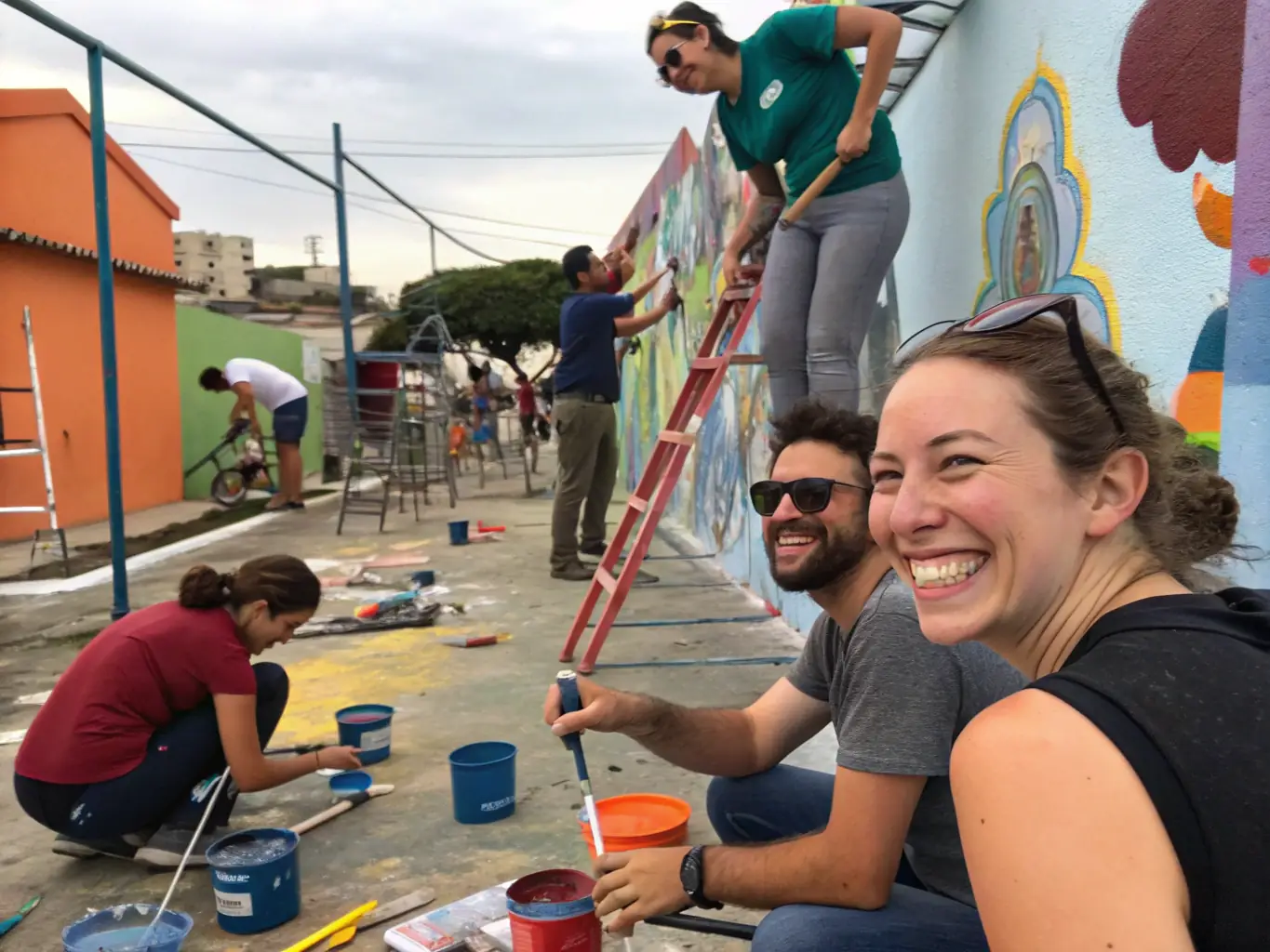 A photograph of a group of volunteers working together on an art installation project, demonstrating ATELIER PLUS's commitment to community engagement and collaborative art creation.